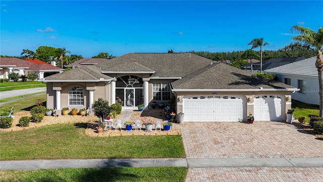 3625 Gaviota Dr, Ruskin, FL 33573 - ranch-style home with stucco siding, decorative driveway, a shingled roof, and a garage