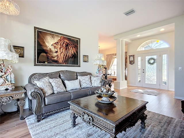 3625 Gaviota Dr, Ruskin, FL 33573 - living room featuring light wood-type flooring, decorative columns, baseboards, visible vents, and recessed lighting