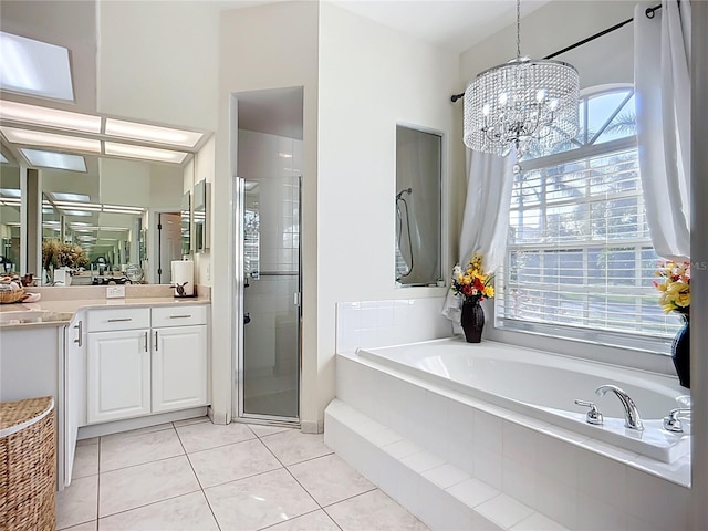 3625 Gaviota Dr, Ruskin, FL 33573 - full bath with a stall shower, an inviting chandelier, tile patterned flooring, a garden tub, and vanity