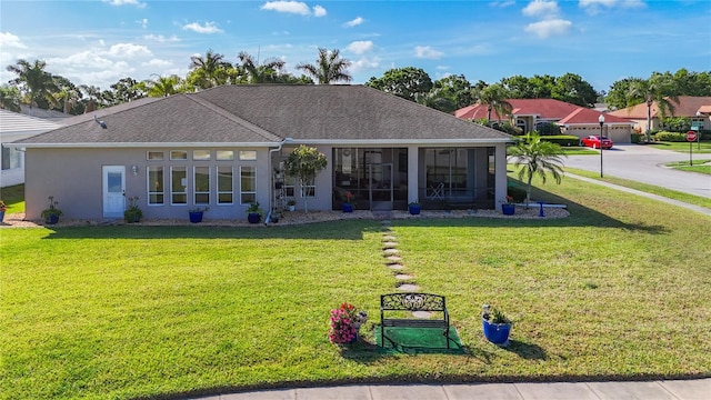 3625 Gaviota Dr, Ruskin, FL 33573 - view of front facade featuring a sunroom, roof with shingles, a front yard, and stucco siding