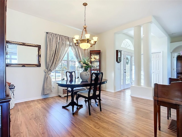 3625 Gaviota Dr, Ruskin, FL 33573 - dining space featuring light wood-style flooring, baseboards, and a notable chandelier