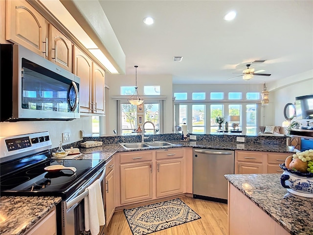 3625 Gaviota Dr, Ruskin, FL 33573 - kitchen with a sink, light wood-style floors, ceiling fan, appliances with stainless steel finishes, and visible vents