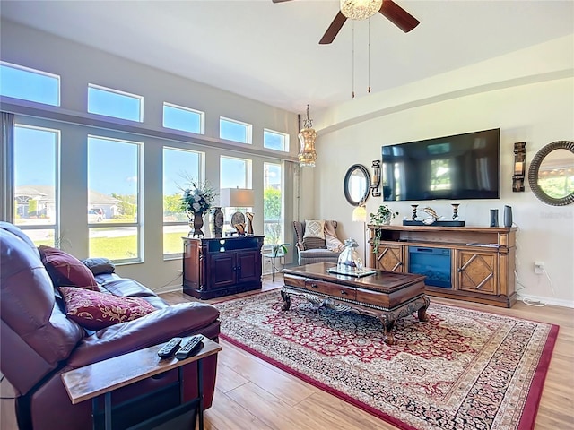 3625 Gaviota Dr, Ruskin, FL 33573 - living room with a fireplace, light wood finished floors, and ceiling fan