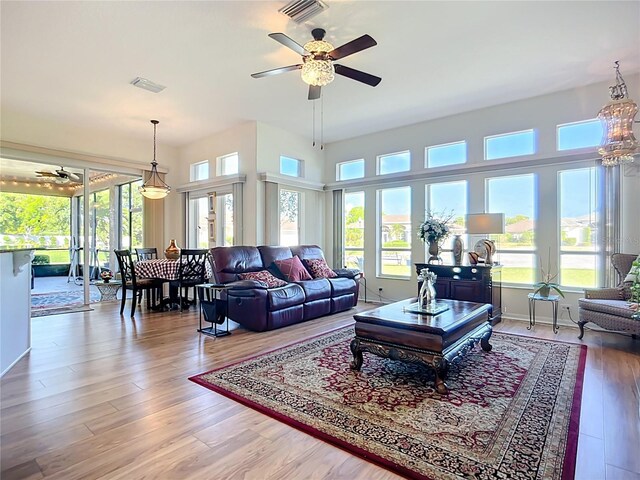 3625 Gaviota Dr, Ruskin, FL 33573 - living area featuring ceiling fan with notable chandelier, plenty of natural light, and visible vents
