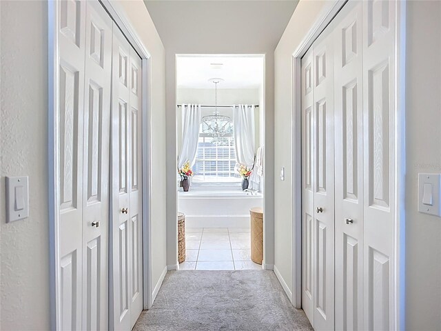 3625 Gaviota Dr, Ruskin, FL 33573 - corridor featuring light tile patterned flooring, baseboards, and light colored carpet