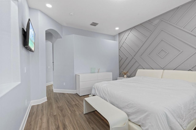14521 Mirasol Manor Ct, Tampa, FL 33626 - bedroom featuring baseboards, wood finished floors, arched walkways, and recessed lighting
