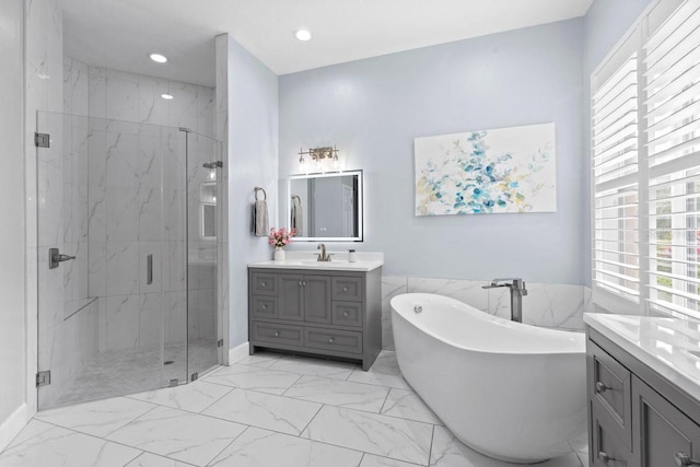 14521 Mirasol Manor Ct, Tampa, FL 33626 - bathroom featuring vanity, marble look tiles, a marble finish shower, a freestanding tub, and plenty of natural light