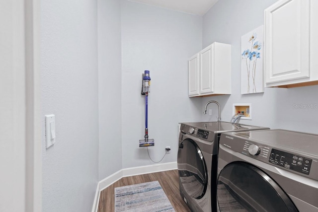 14521 Mirasol Manor Ct, Tampa, FL 33626 - laundry room with cabinet space, dark wood-style flooring, independent washer and dryer, and baseboards