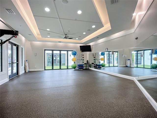 17228 Holly Well Ave, Wimauma, FL 33598 - gym featuring a tray ceiling, french doors, ceiling fan, and recessed lighting