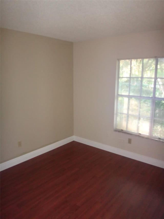 665 Oak Harbour Dr Unit 115, Altamonte Springs, FL 32701 - empty room featuring baseboards and dark wood finished floors