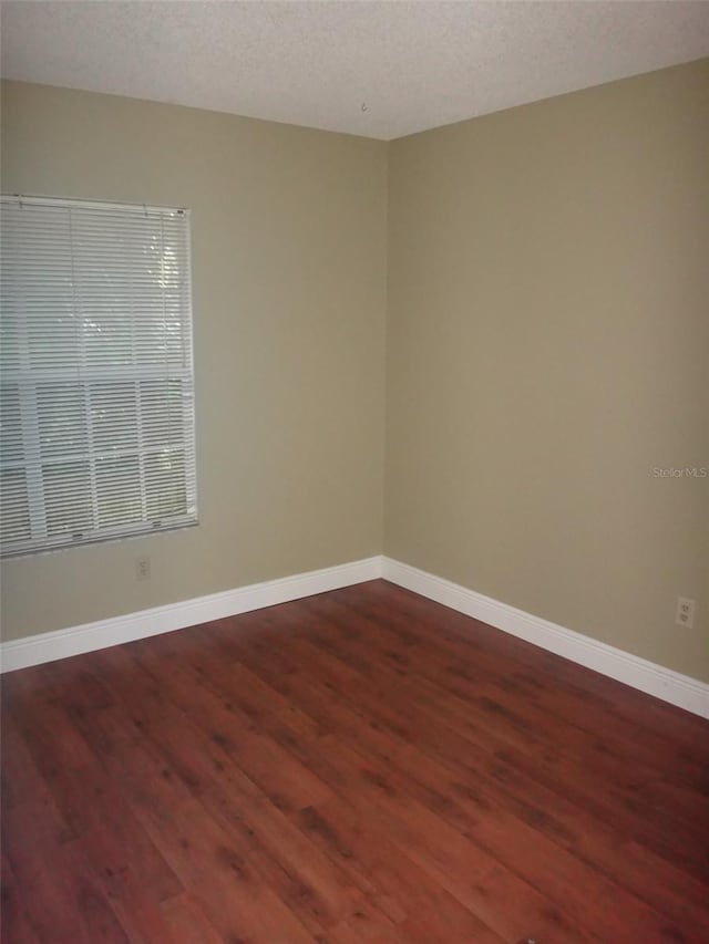 665 Oak Harbour Dr Unit 115, Altamonte Springs, FL 32701 - empty room featuring baseboards, a textured ceiling, and wood finished floors
