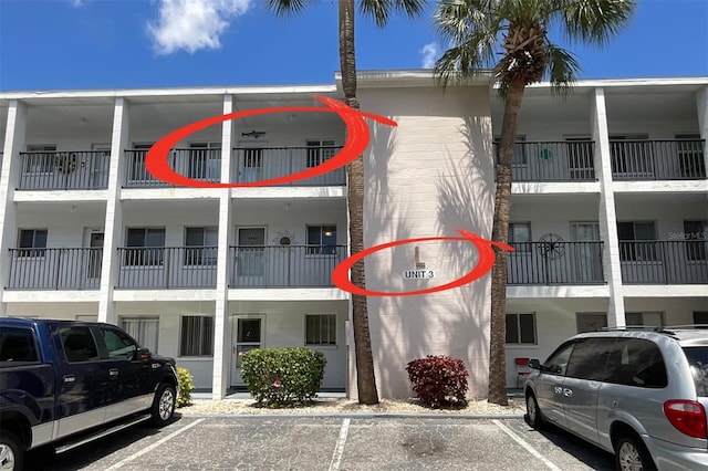 view of building exterior with uncovered parking