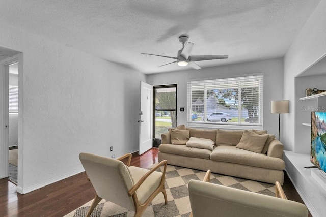 129 NW Lincoln Cir N, Saint Petersburg, FL 33702 - living area featuring a textured ceiling, baseboards, a ceiling fan, wood finished floors, and a textured wall