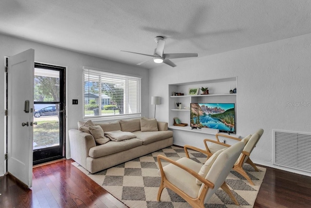 129 NW Lincoln Cir N, Saint Petersburg, FL 33702 - living room with a textured ceiling, wood finished floors, visible vents, and a ceiling fan