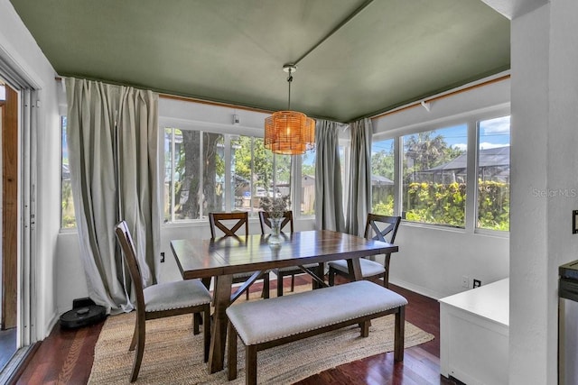129 NW Lincoln Cir N, Saint Petersburg, FL 33702 - dining area featuring dark wood finished floors and baseboards