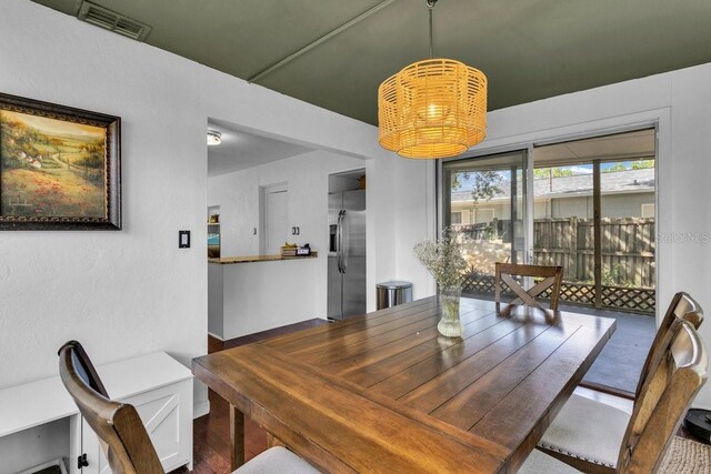 129 NW Lincoln Cir N, Saint Petersburg, FL 33702 - dining space featuring an inviting chandelier and visible vents