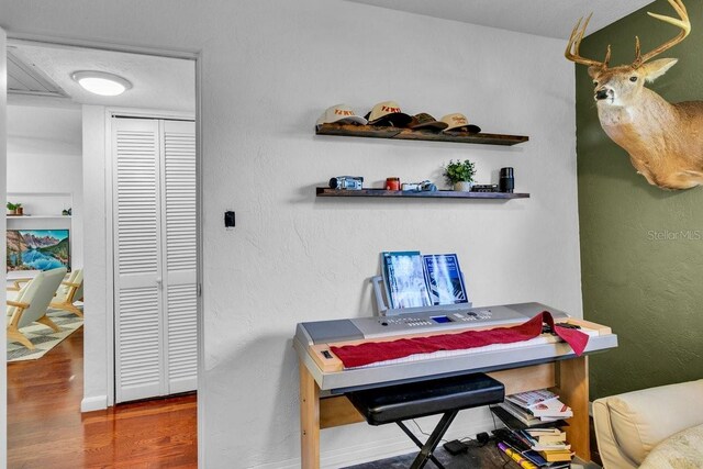 129 NW Lincoln Cir N, Saint Petersburg, FL 33702 - home office featuring a textured wall and wood finished floors