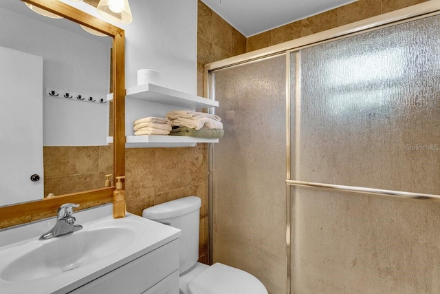 129 NW Lincoln Cir N, Saint Petersburg, FL 33702 - bathroom featuring vanity, toilet, a stall shower, and tile walls