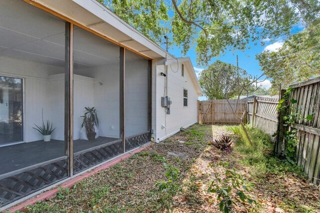 129 NW Lincoln Cir N, Saint Petersburg, FL 33702 - view of yard with a sunroom and a fenced backyard