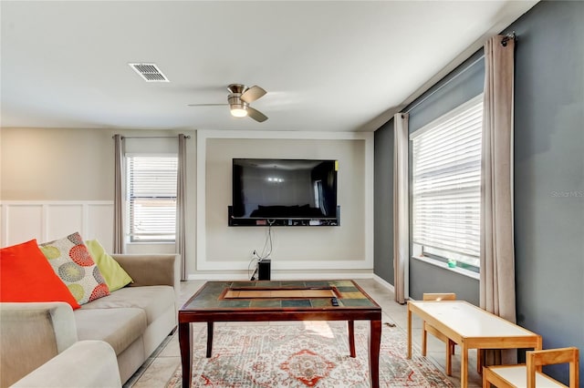 living room featuring visible vents and a ceiling fan