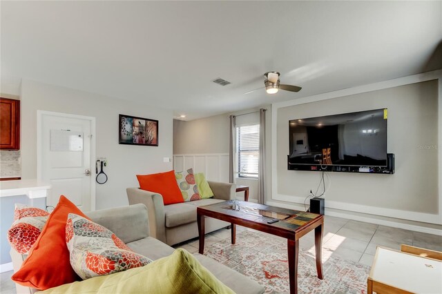 living room featuring visible vents, a ceiling fan, and light tile patterned flooring