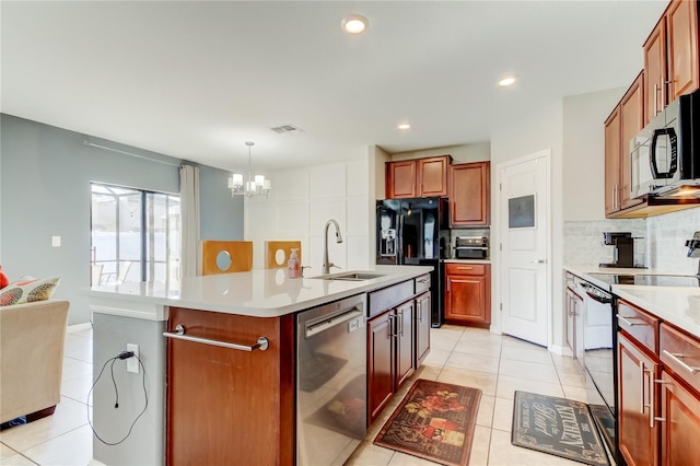 kitchen featuring tasteful backsplash, light tile patterned floors, black appliances, visible vents, and a sink
