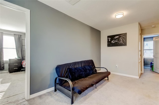 living area featuring carpet flooring, baseboards, and visible vents