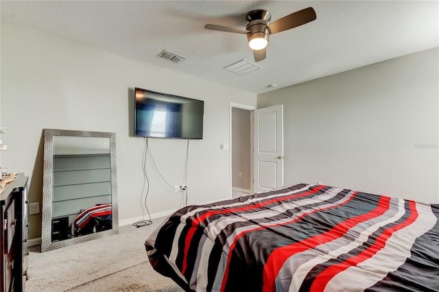 carpeted bedroom with baseboards, a ceiling fan, and visible vents