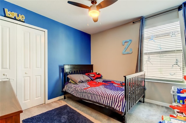 bedroom with a closet, carpet, and baseboards