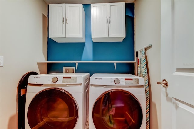 clothes washing area with independent washer and dryer and cabinet space