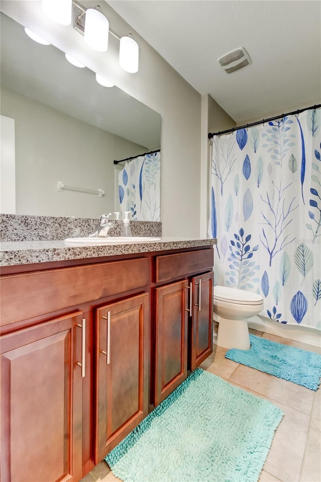 bathroom featuring visible vents, a shower with curtain, toilet, vanity, and tile patterned flooring