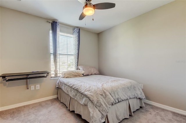 bedroom with light carpet, baseboards, and ceiling fan