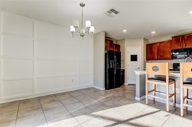 13923 Arbor Pines Dr, Riverview, FL 33579 - kitchen featuring black appliances, a chandelier, backsplash, reddish brown cabinets, and light tile patterned floors