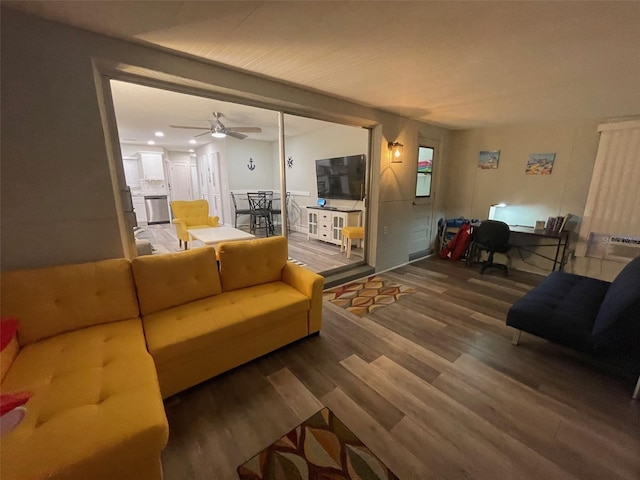 living area with wood finished floors, a desk, and ceiling fan