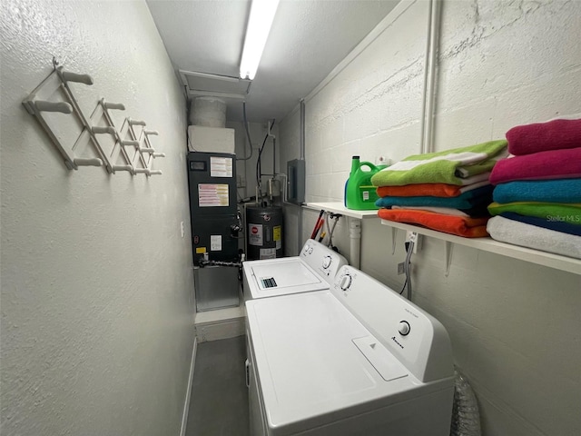 laundry room with independent washer and dryer, concrete block wall, and electric water heater