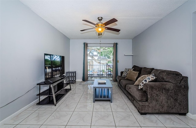 living room with ceiling fan, baseboards, and marble finish floor