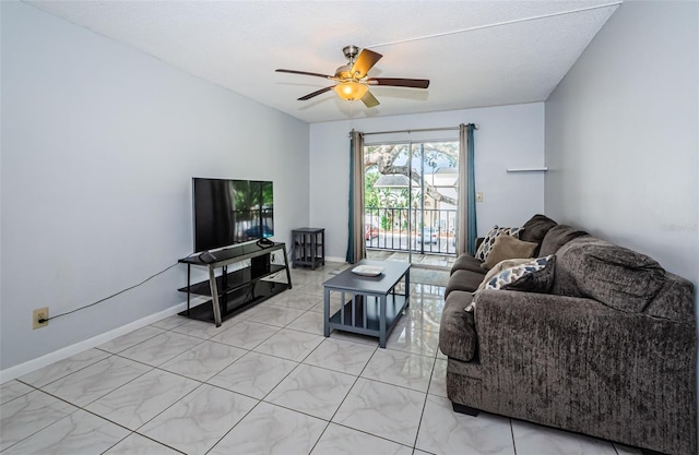 living room featuring ceiling fan and baseboards