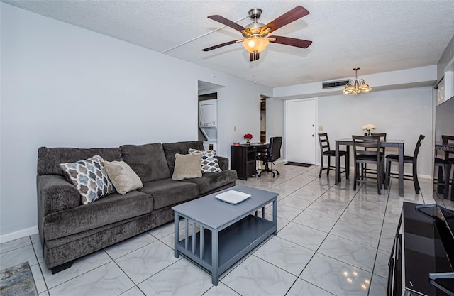 living room featuring a textured ceiling, visible vents, marble finish floor, and ceiling fan with notable chandelier