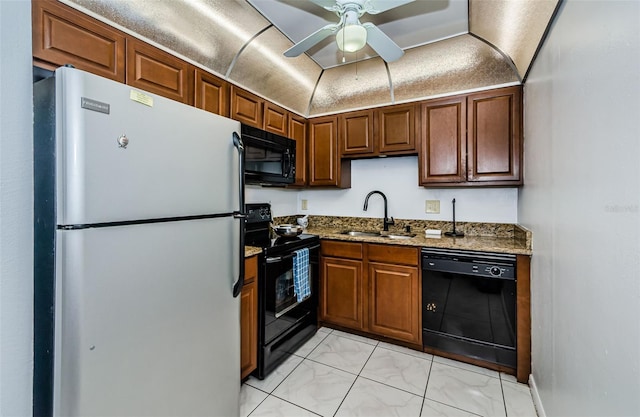 kitchen featuring ceiling fan, a sink, black appliances, dark stone countertops, and marble finish floor
