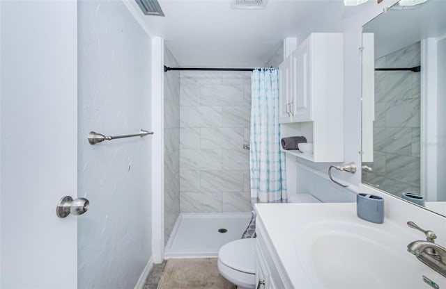 full bath with vanity, a shower stall, toilet, and visible vents