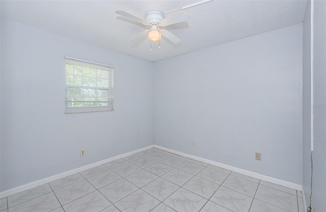 unfurnished room featuring baseboards and ceiling fan