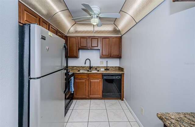 kitchen featuring a sink, stone countertops, marble finish floor, a ceiling fan, and black appliances