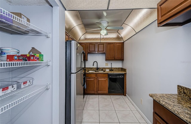 kitchen with ceiling fan, a sink, marble finish floor, black dishwasher, and freestanding refrigerator