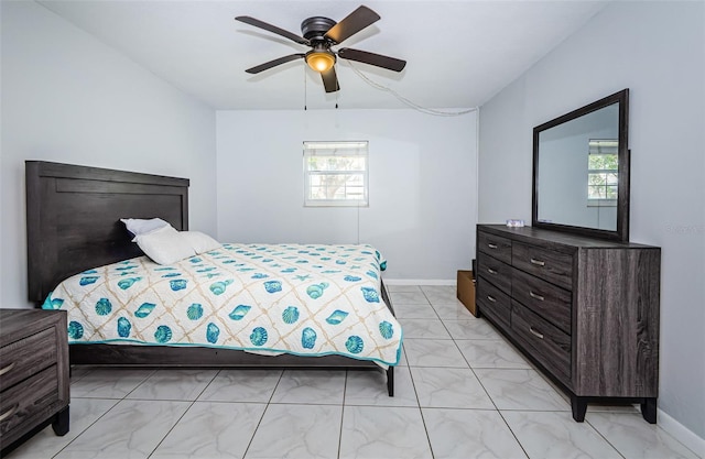 bedroom featuring baseboards, multiple windows, and marble finish floor