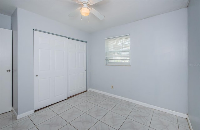 unfurnished bedroom featuring baseboards, a ceiling fan, and a closet