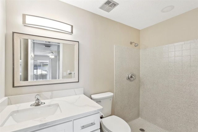 1203 16th Cir SE, Largo, FL 33771 - bathroom with tiled shower, toilet, and vanity