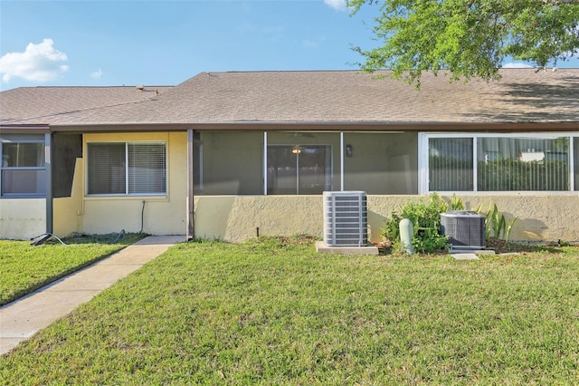 1203 16th Cir SE, Largo, FL 33771 - back of house with central air condition unit, a lawn, and roof with shingles