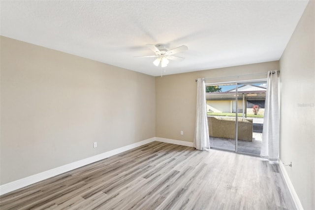 1203 16th Cir SE, Largo, FL 33771 - spare room featuring a ceiling fan, wood finished floors, baseboards, and a textured ceiling