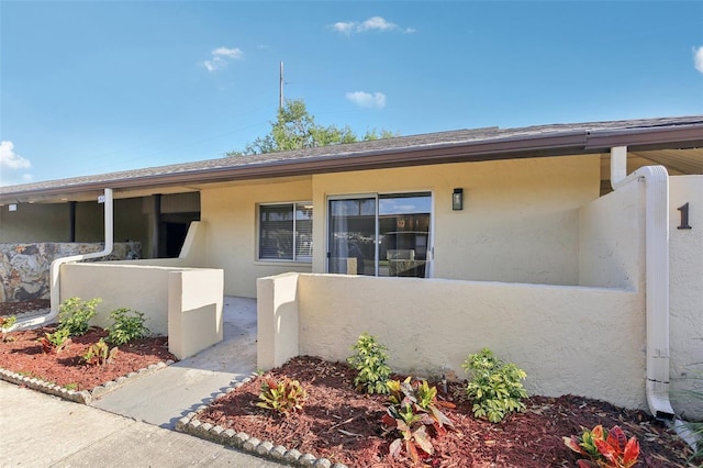 1203 16th Cir SE, Largo, FL 33771 - property entrance with stucco siding