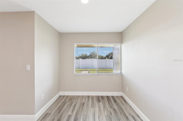 1203 16th Cir SE, Largo, FL 33771 - spare room with baseboards and light wood finished floors